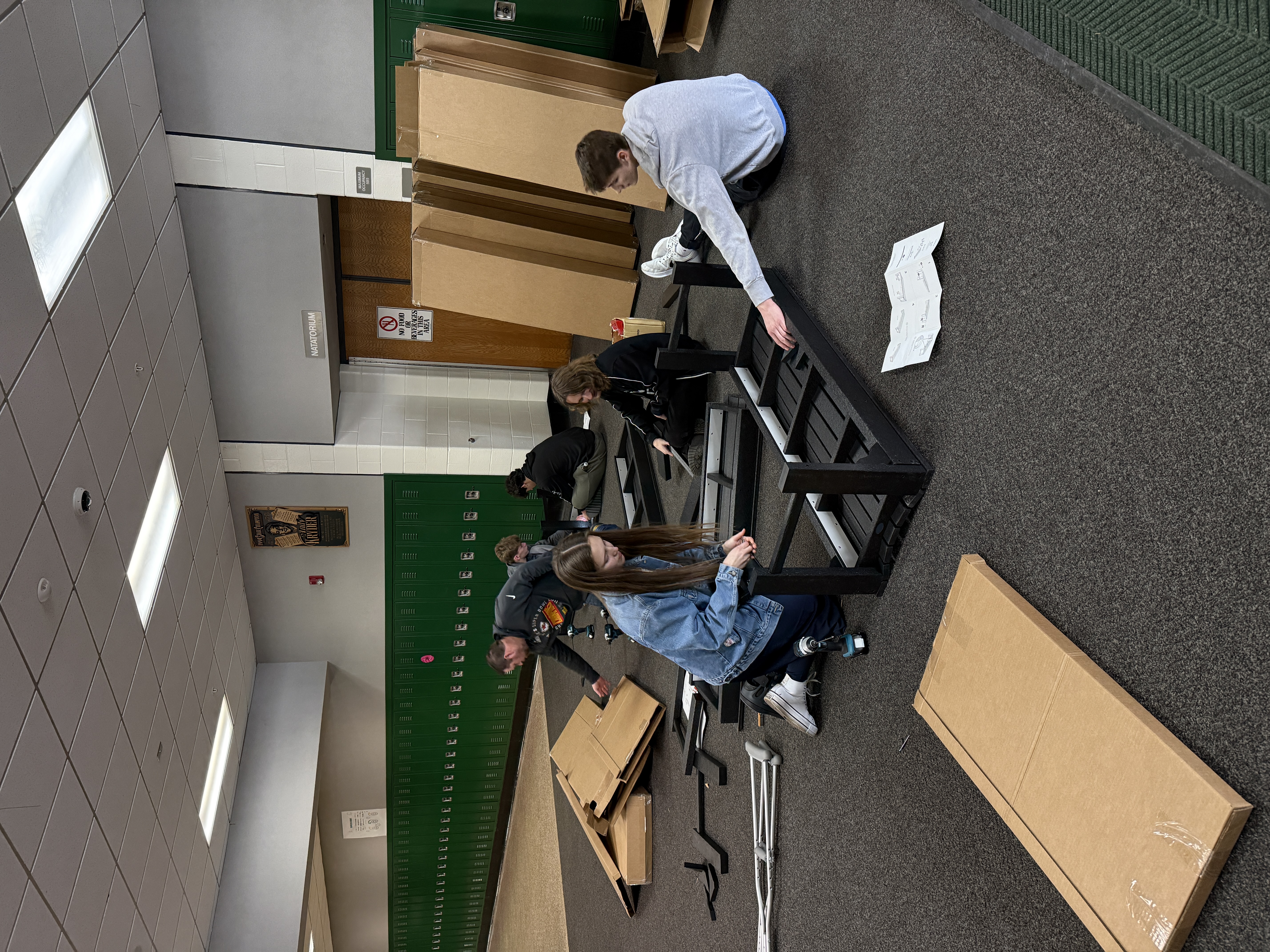 POLYWOOD Academy students assemble benches inside Wawasee High School